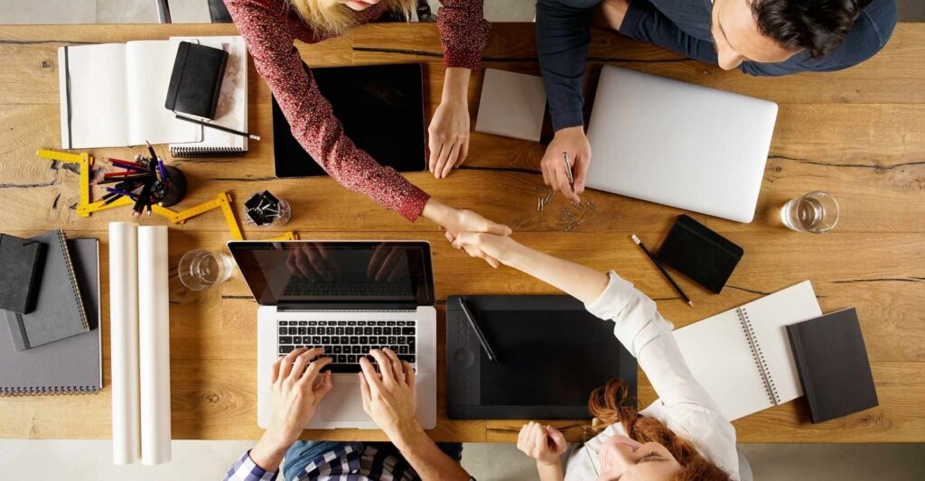 birds eye view of a meeting table and handshake